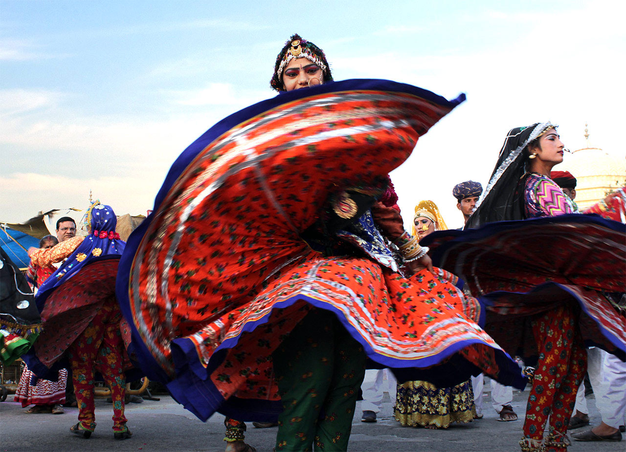 Women performing Ghoomar dance in colorful Rajasthani attire