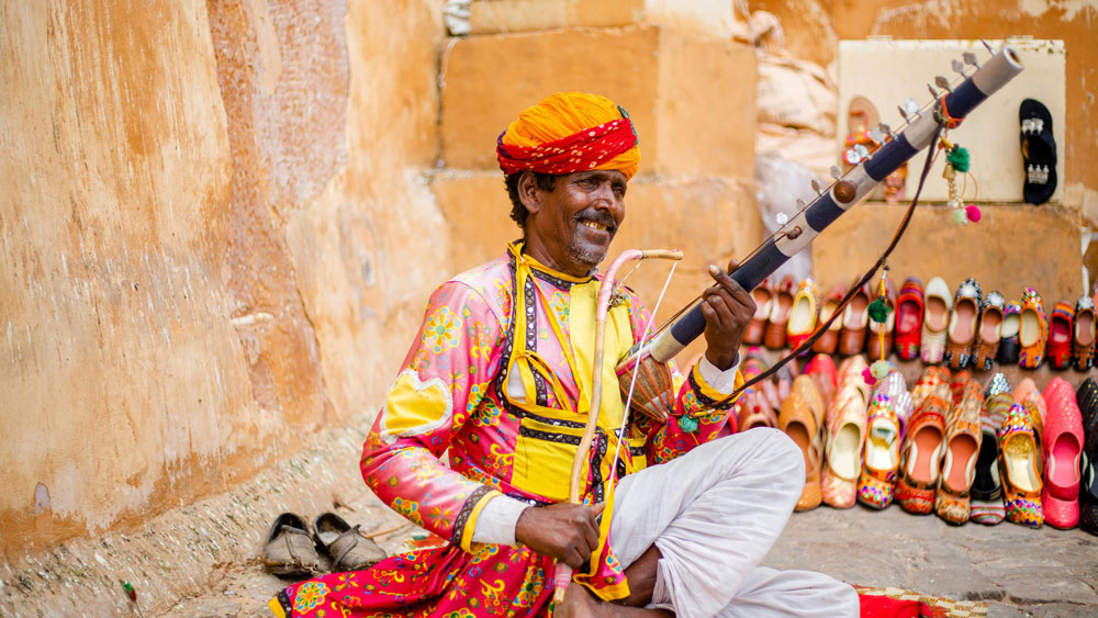 Rajasthan folk culture performers in traditional attire dancing and playing instruments