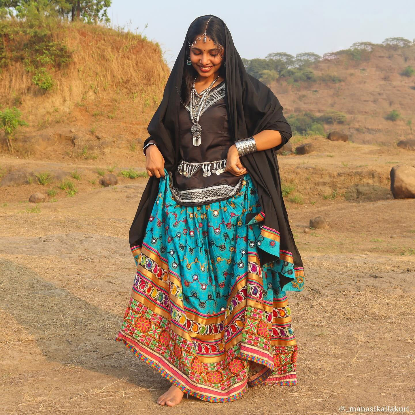 Rajasthani woman in traditional Ghagra with colorful embroidery and mirror work.