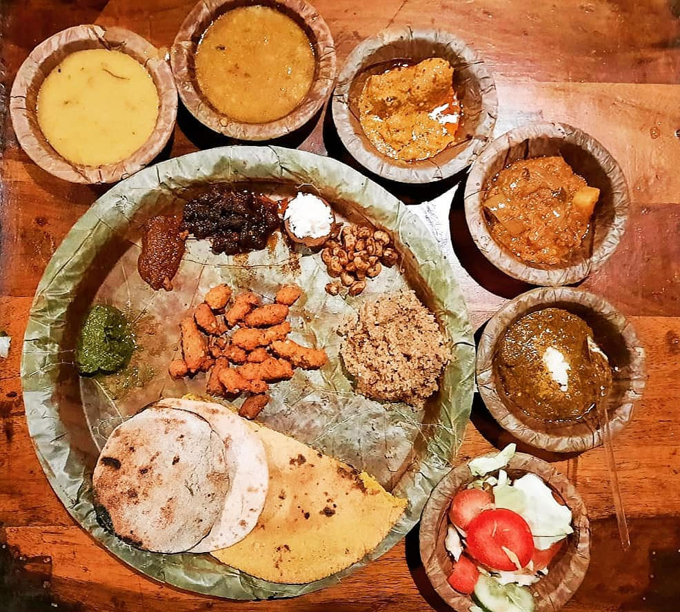 Rajasthani thali with dal, churma, gatte ki sabzi, and traditional breads.